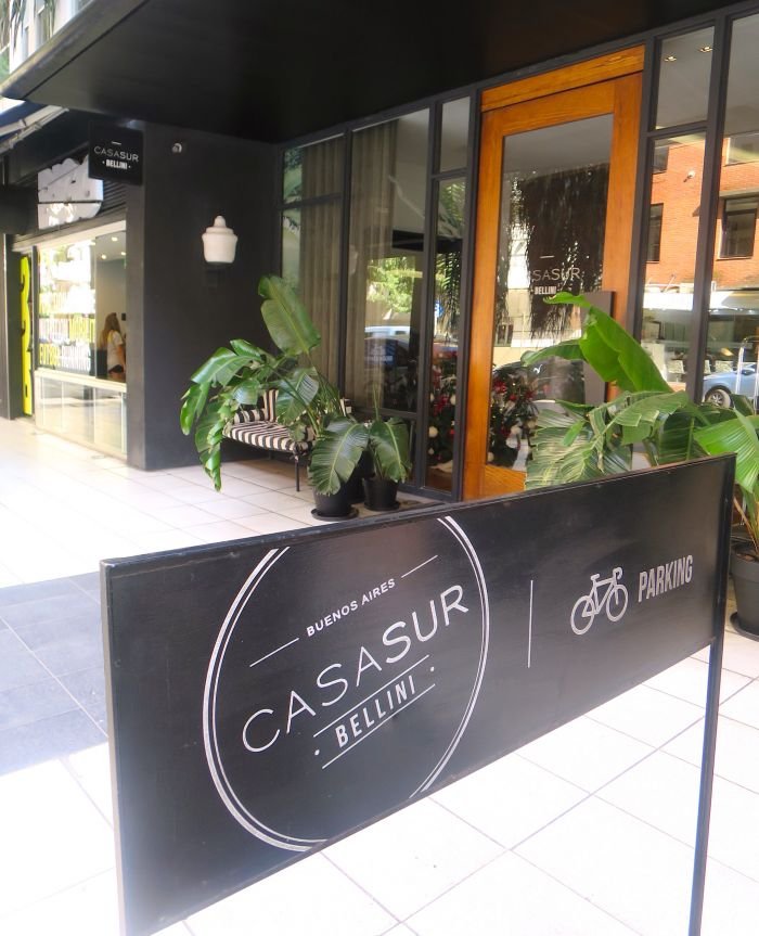 A black sign on a window Description automatically generated