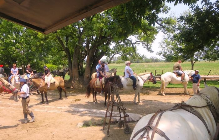 A group of people riding on the back of a horse Description automatically generated