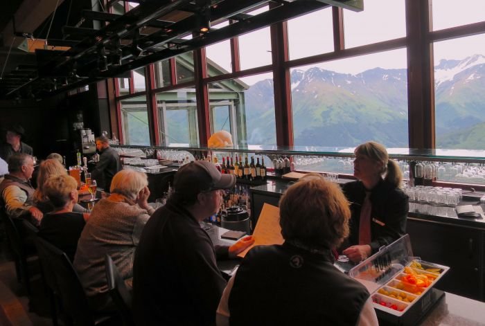 A group of people sitting at a table in a restaurant Description automatically generated