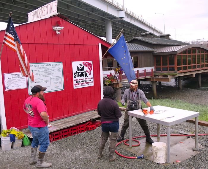 A group of people standing in front of a building Description automatically generated