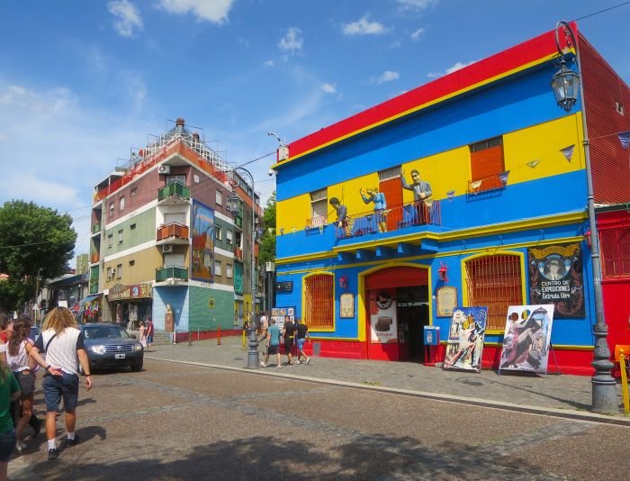 A group of people standing in front of a building Description automatically generated