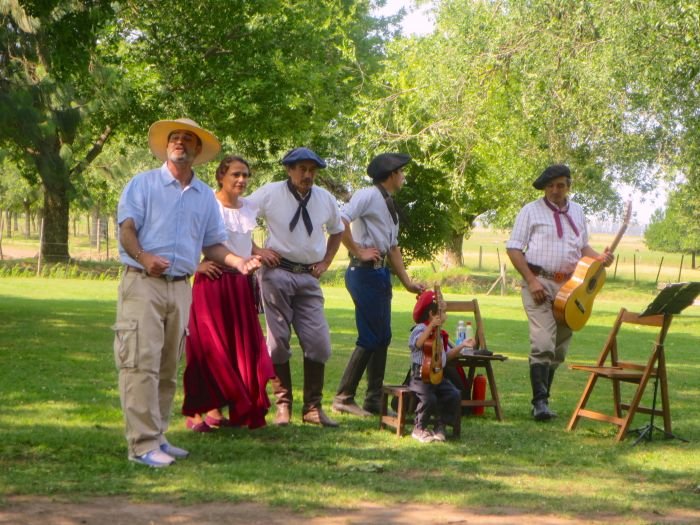 A group of people that are standing in the grass Description automatically generated