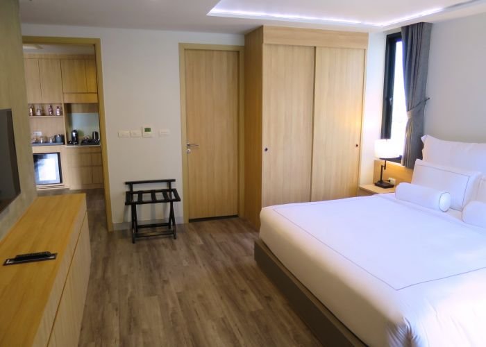 A bedroom with a large bed in a room Description automatically generated