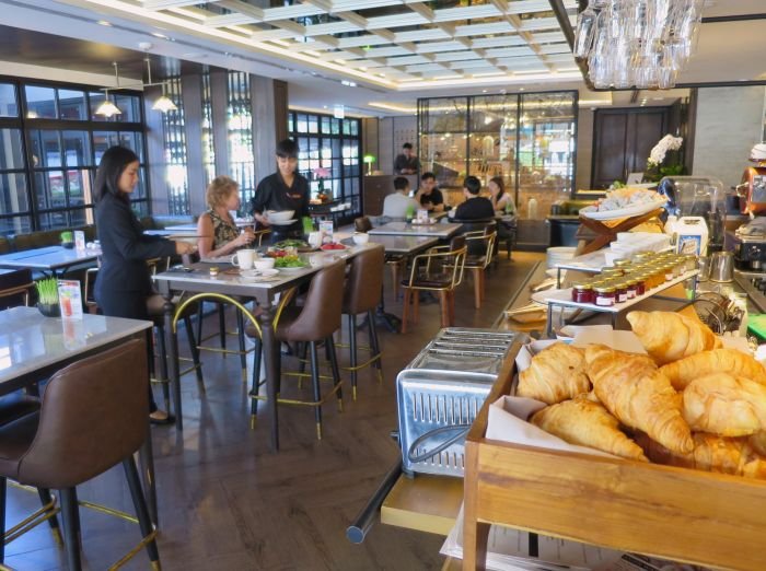 A group of people eating food at a restaurant Description automatically generated