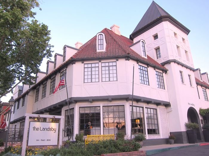 A house that has a sign on the side of a building

Description automatically generated