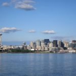 A large body of water with a city in the background Description automatically generated