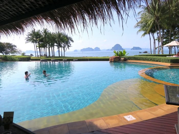 A pool next to a body of water

Description automatically generated