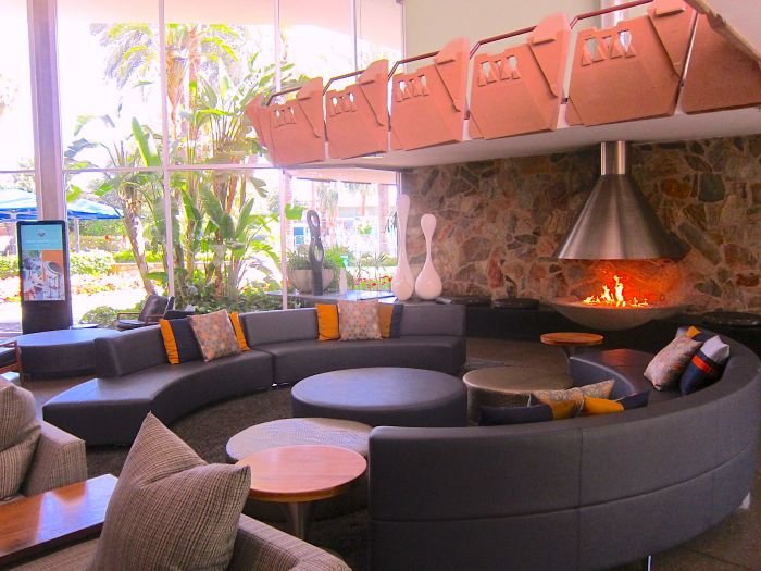 A room filled with furniture and a large window Description automatically generated