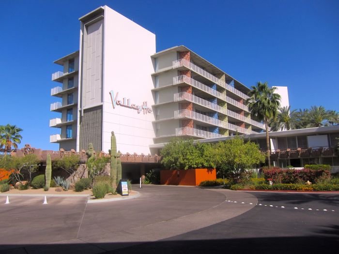 An empty road with trees on the side of a building

Description automatically generated