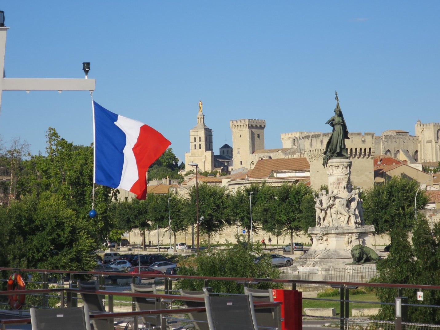 A flag flying over a city Description automatically generated