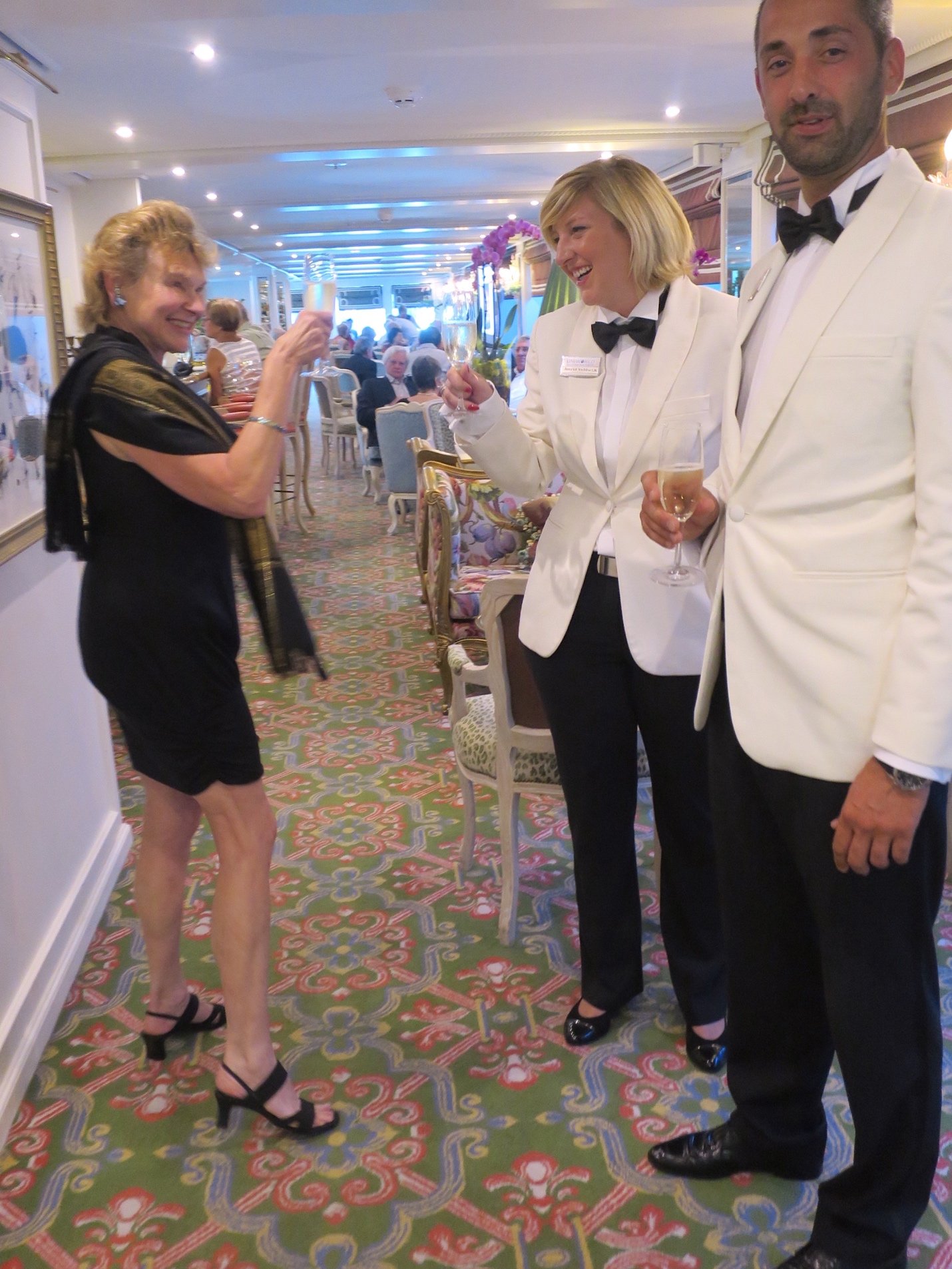 A group of people standing in a room Description automatically generated