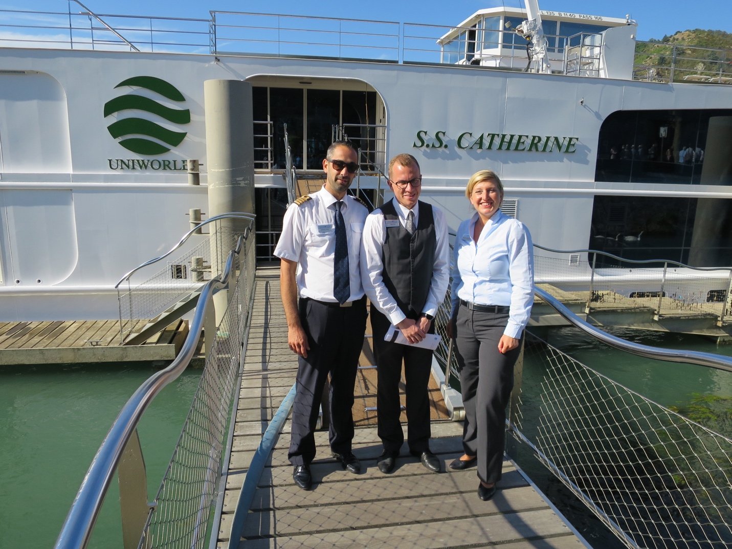 A group of people standing in front of a bus Description automatically generated