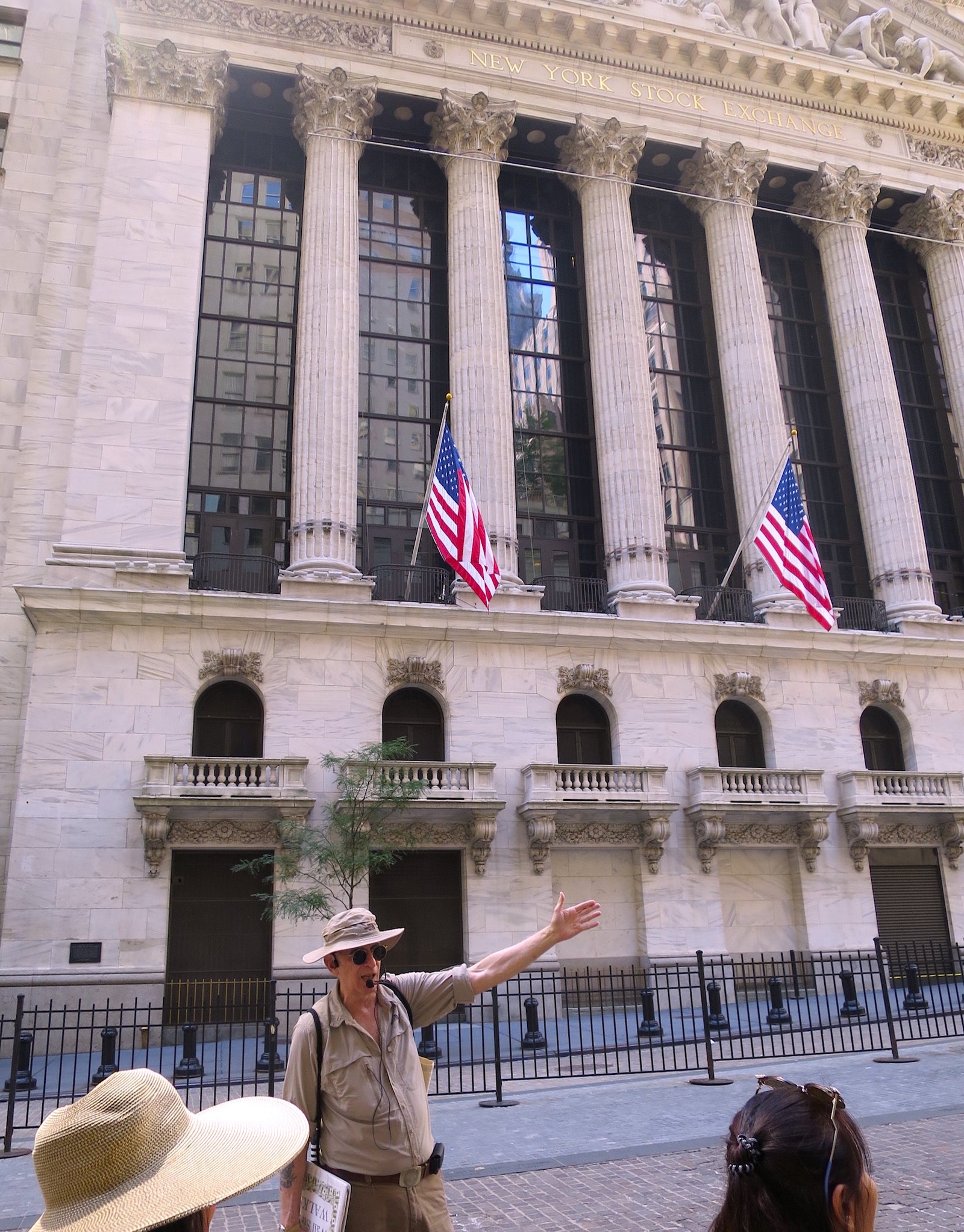 A group of people walking in front of a buildingDescription automatically generated